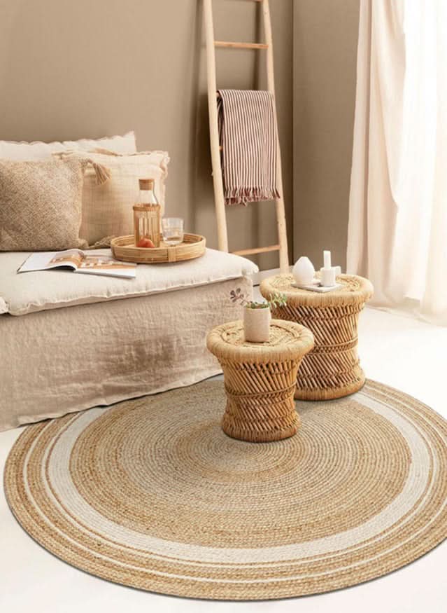 Natural fiber Round Jute Rug with cream accent, in a cozy living space.