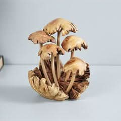 Hand-carved mushroom sculpture in natural wood tones, detailed home decor piece.
