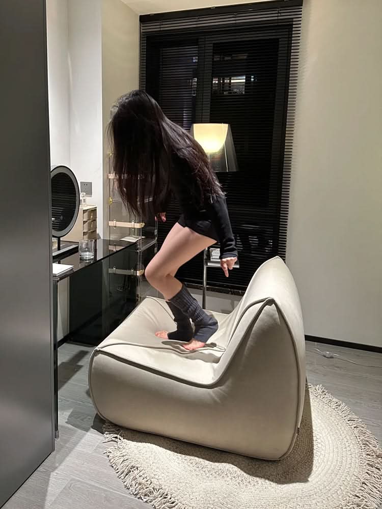 Round wool braided rug in neutral tones, complementing modern home decor.