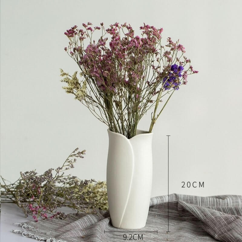 Abstract White Flower Vase with dried flowers on a rustic cloth.