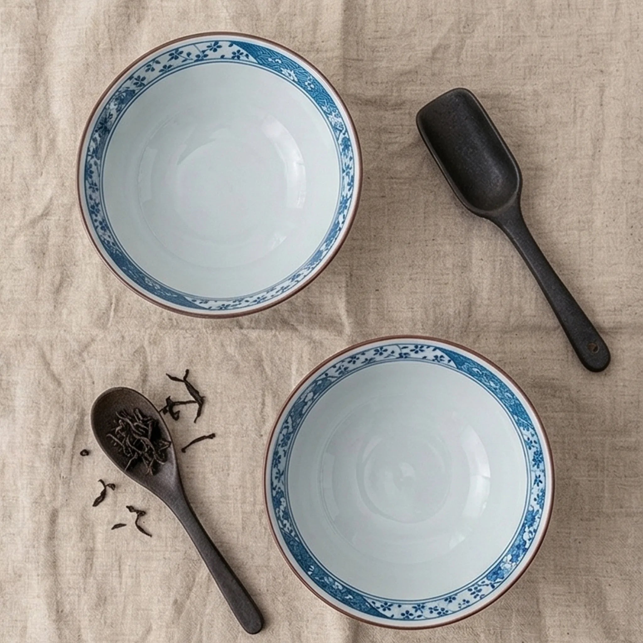 Japanese Style Ceramic Rice Bowl with Auspicious Flower & Wave Pattern - Blue & Red — overhead flat-lay on linen surface
