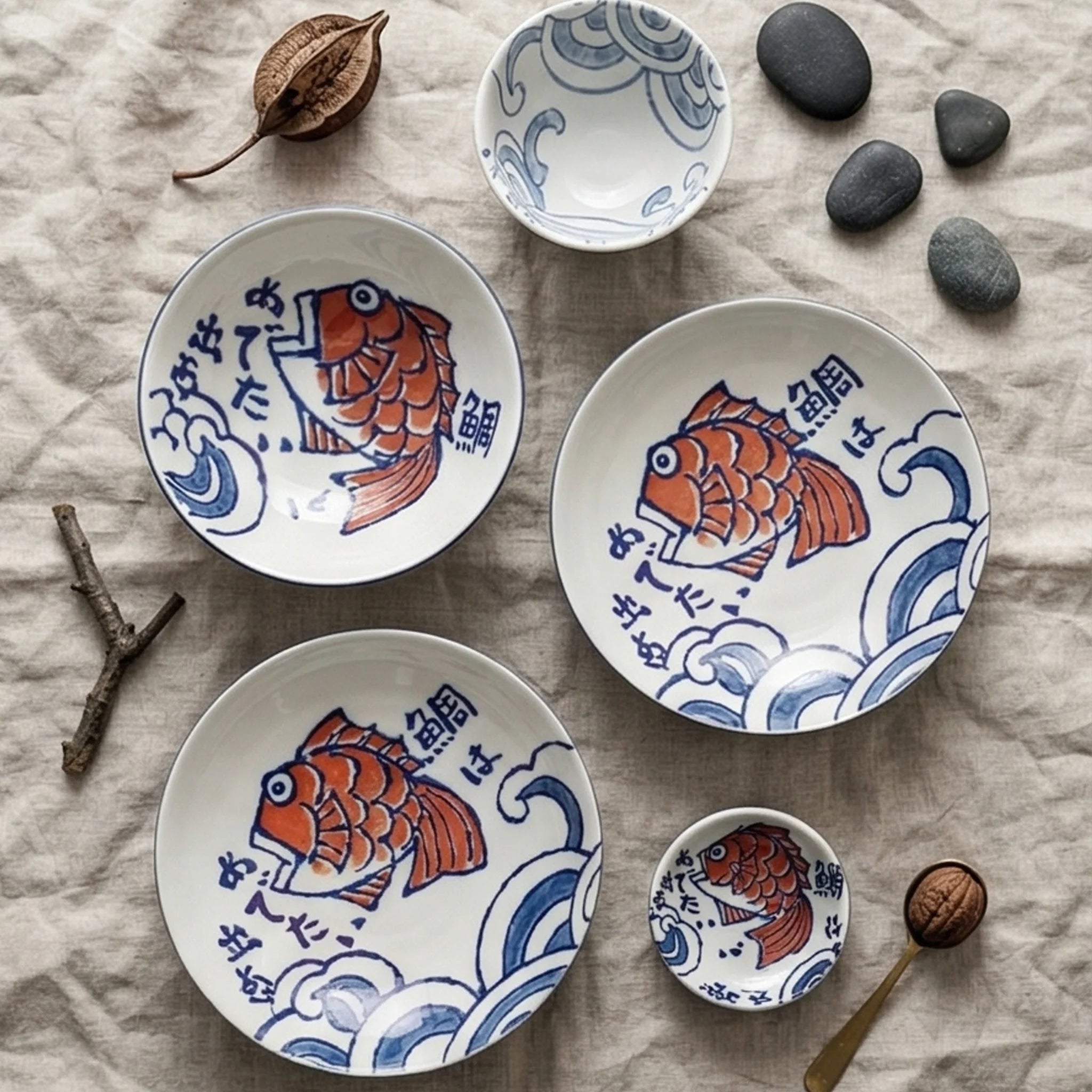 Japanese Style Ceramic Dinnerware Set - Red Fish & Wave Design Bowl and Plate Collection — overhead flat-lay on linen surface