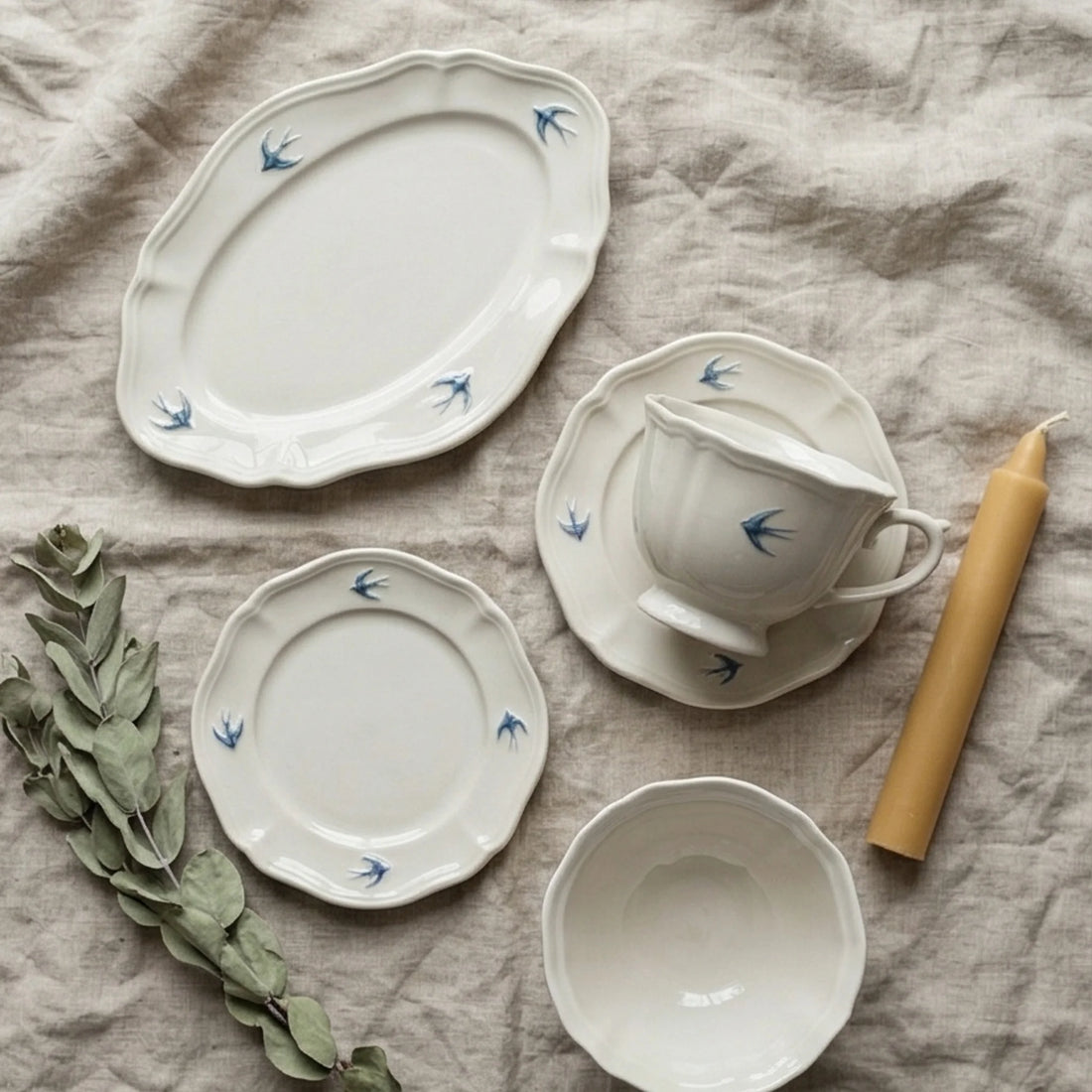 Vintage Ceramic Tableware Set with Blue Swallow Design - Dishware Collection — overhead flat-lay on linen surface