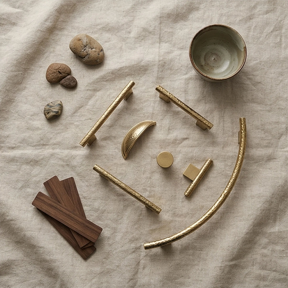 Handmade Hammered Brass Cabinet Pulls and Knobs - Luxury Gold Drawer Handles — overhead flat-lay on linen surface