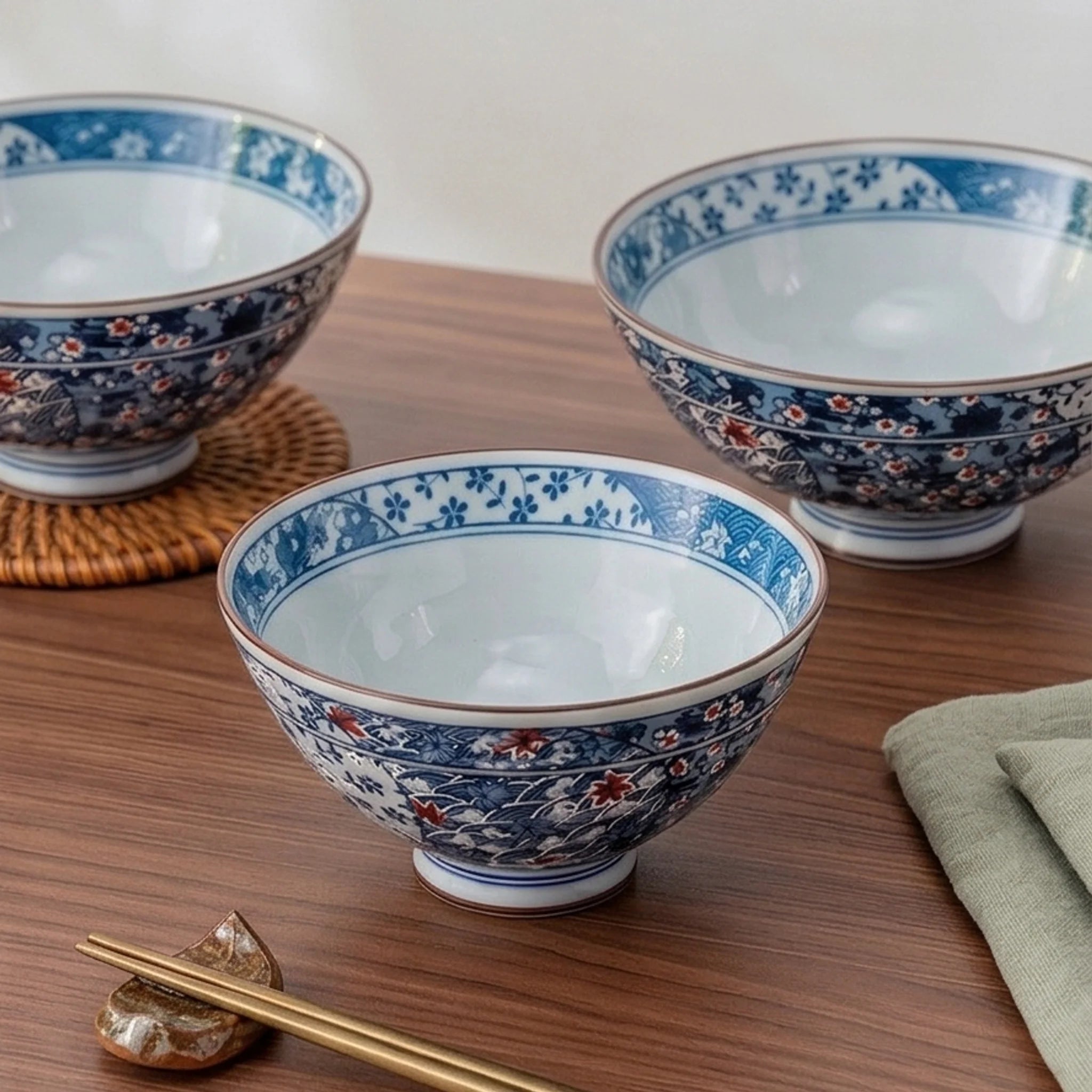 Japanese Style Ceramic Rice Bowl with Auspicious Flower & Wave Pattern - Blue & Red — lifestyle dining table scene with natural props