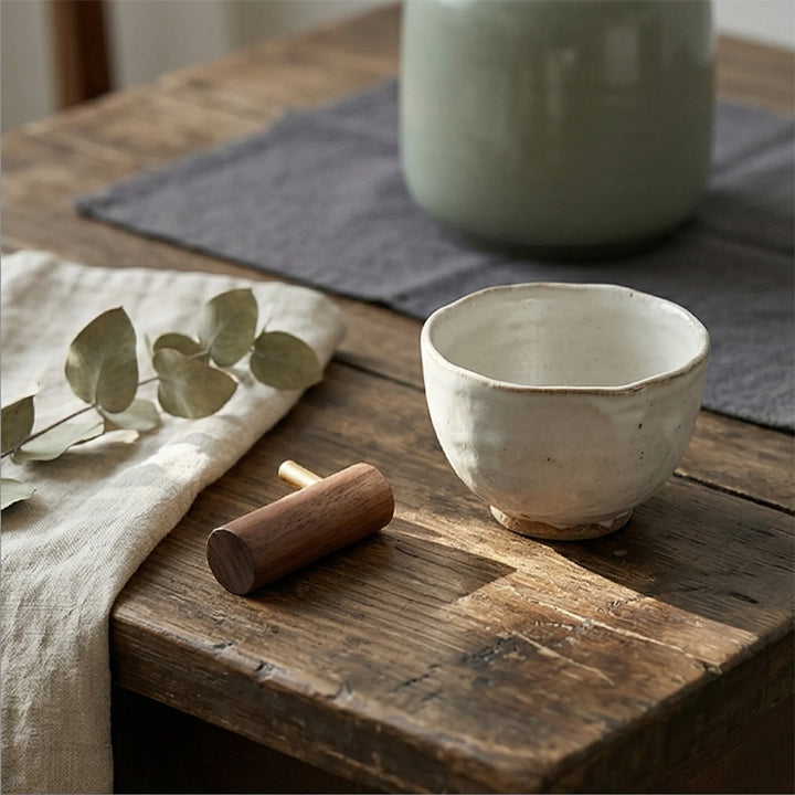 Solid Wood Walnut Wall Hook with Brass Peg for Headphone or Coat Hanging — lifestyle dining table scene with natural props