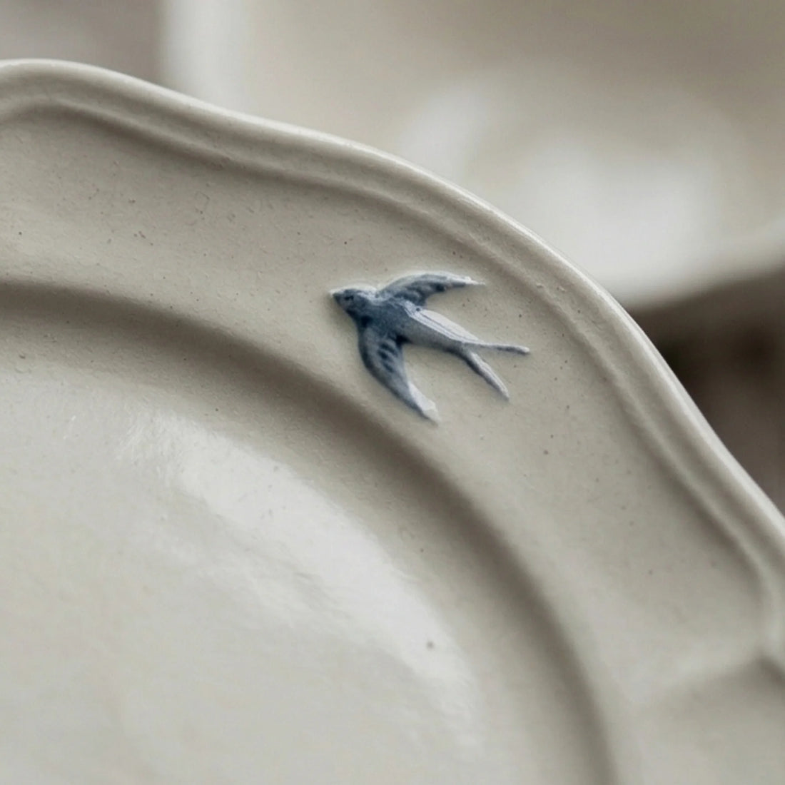 Vintage Ceramic Tableware Set with Blue Swallow Design - Dishware Collection — macro close-up of ceramic glaze texture and finish