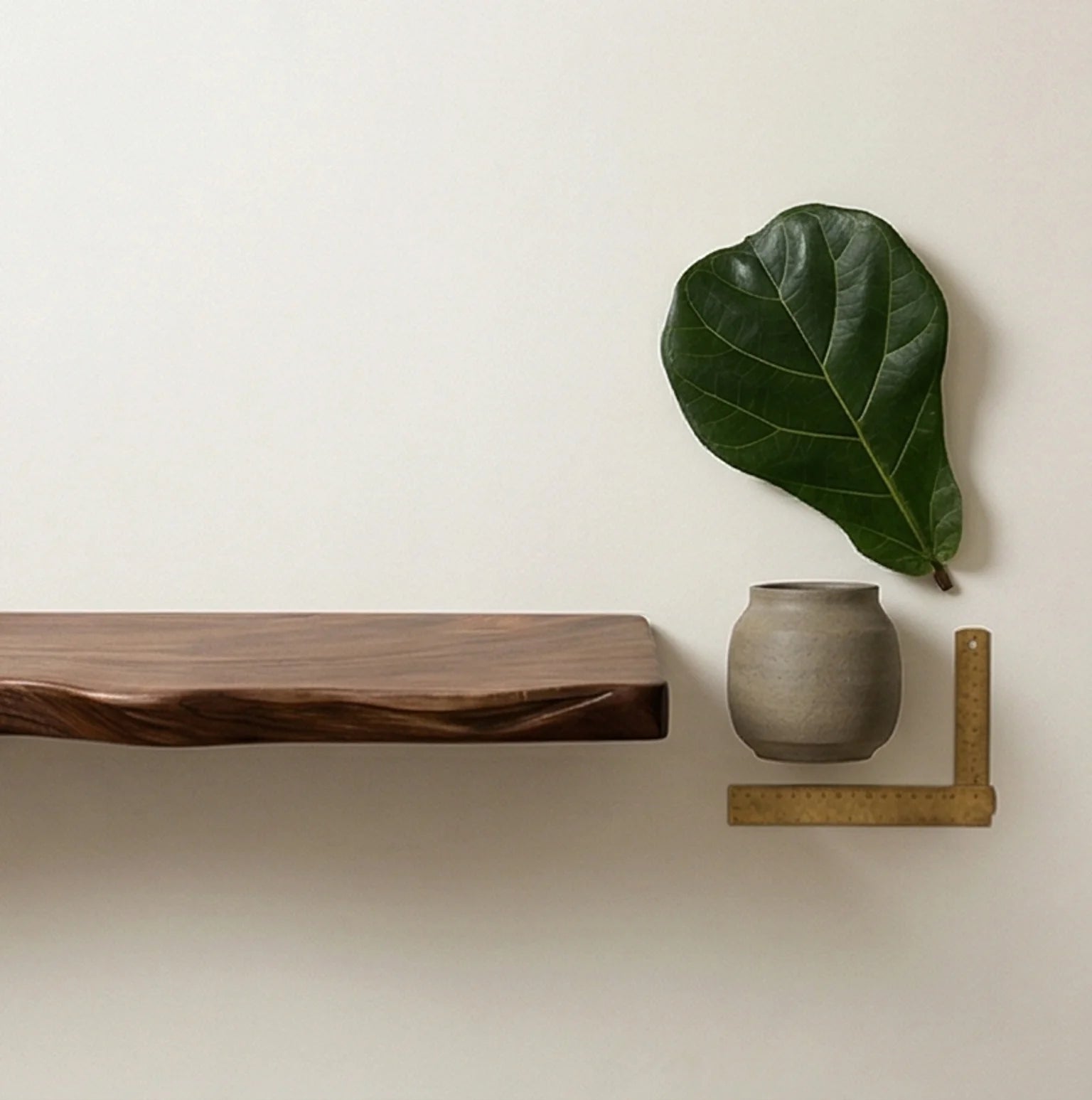 Solid Wood Floating Wall Shelf with Natural Irregular Edge — scale reference alongside natural prop