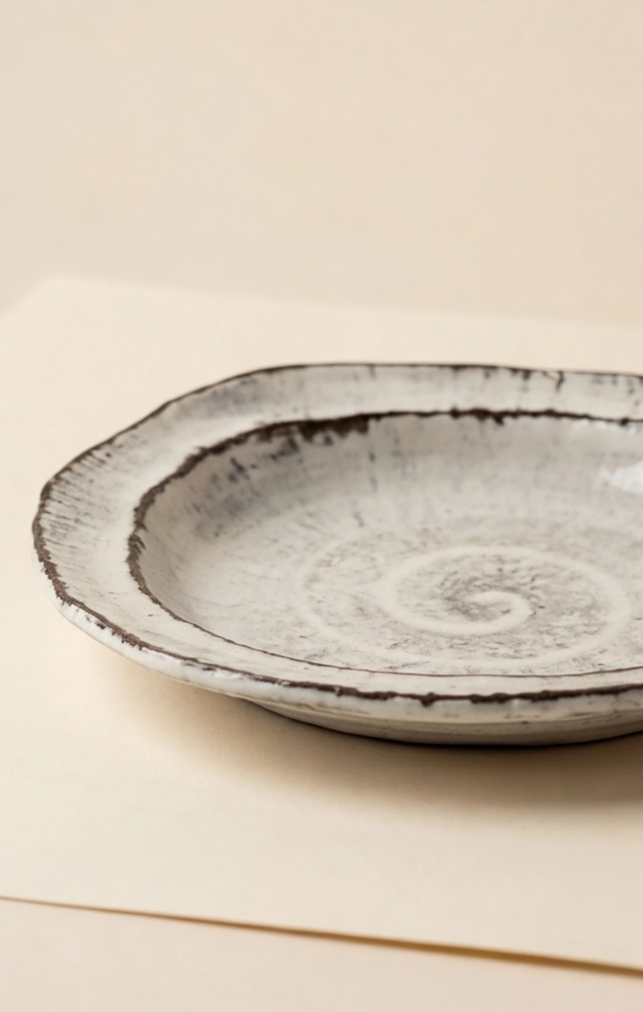 Handmade Irregular Ceramic Plate | Japanese Style Rustic Pottery Dish (19x18cm) — studio 45-degree angle shot showing handle detail