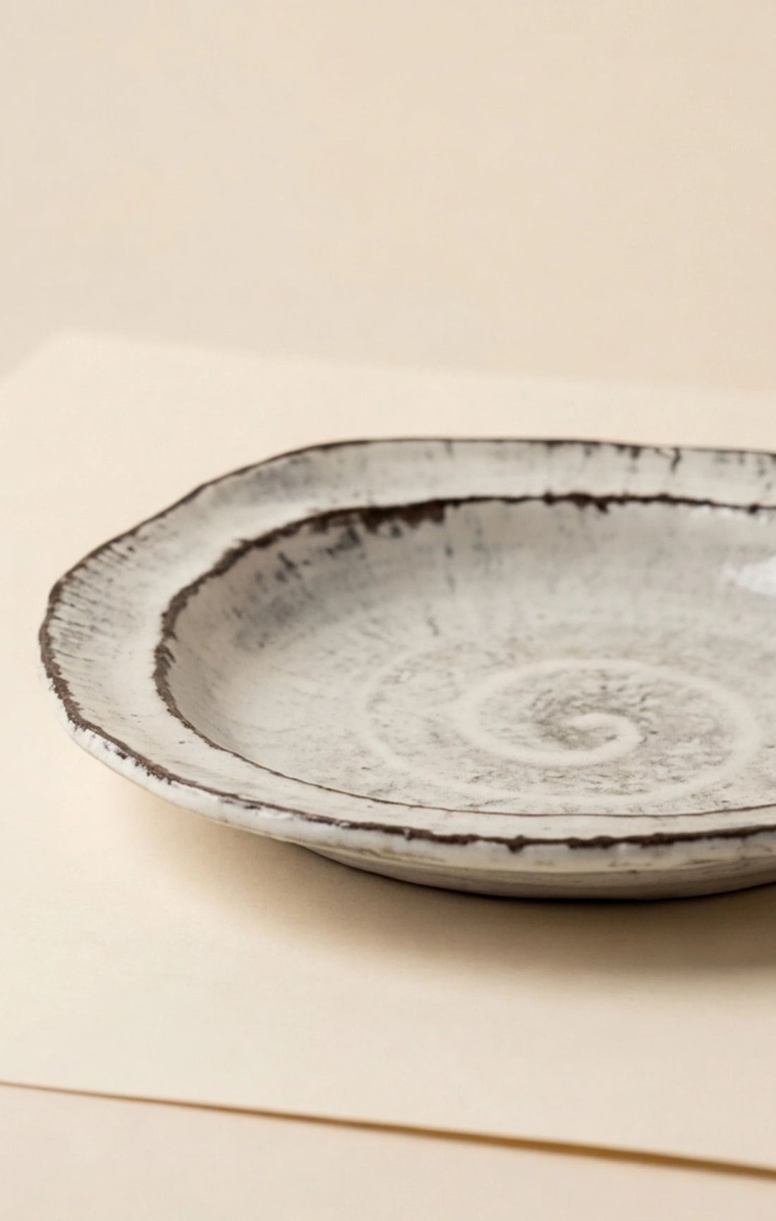 Handmade Irregular Ceramic Plate | Japanese Style Rustic Pottery Dish (19x18cm) — studio 45-degree angle shot showing handle detail