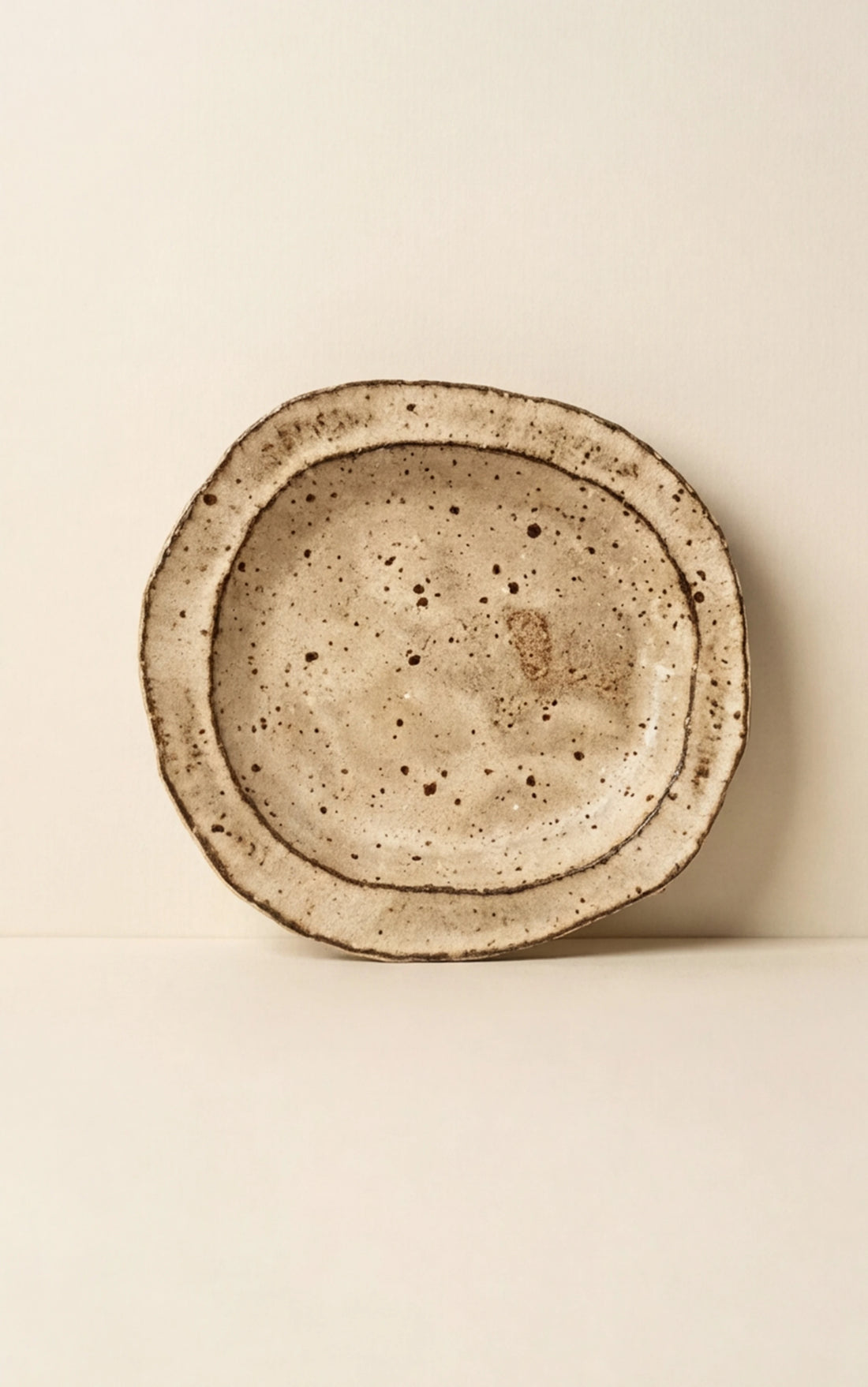 Handmade Irregular Ceramic Plate | Japanese Style Rustic Pottery Dish (19x18cm) — studio 45-degree angle shot showing handle detail (v4 refined)