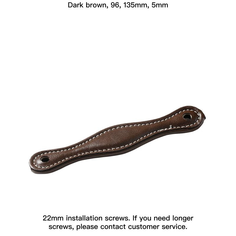 Brown leather-wrapped drawer pulls and cabinet handles, modern farmhouse style, stitched detail.