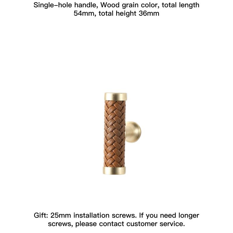 Woven leather drawer pull with gold tone hardware, wood grain detail.