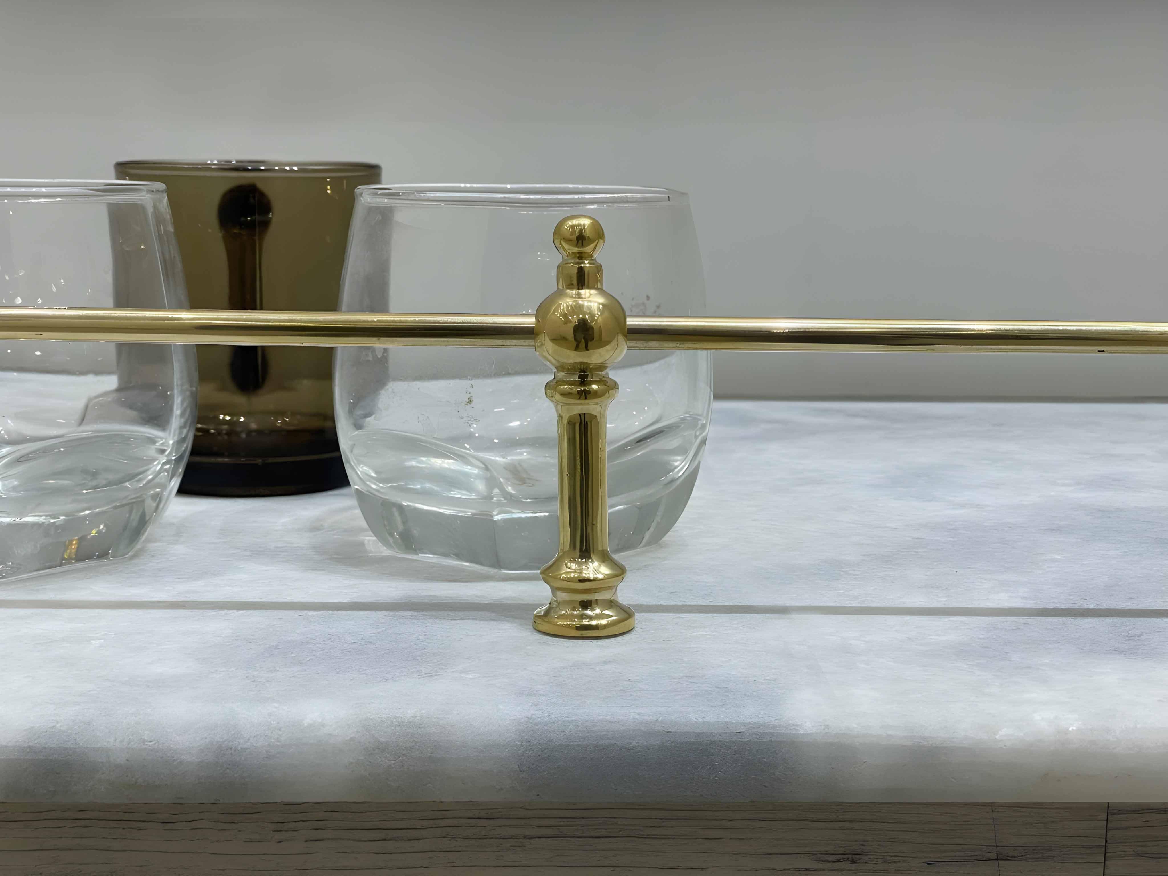 Victorian Brass Gallery Rail, polished brass finish, elegantly displayed with clear and tinted glasses on a light surface.