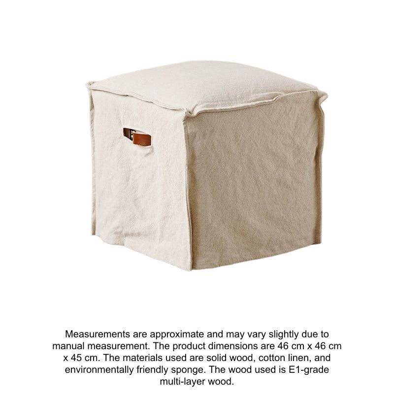 Beige linen square footstool, modern minimalist style.  Square design, covered in linen fabric.  Light beige color.  Wooden floor visible.