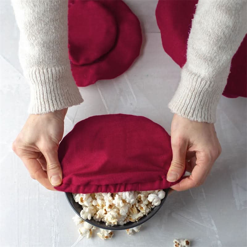 Deep red linen bowl covers shown over popcorn, perfect for home decor and food.