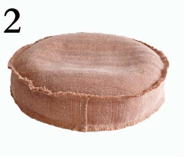 Cotton distressed meditation pillow, rustic earth tone, round cushion with frayed edges.