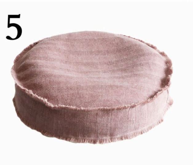 Round blush pink cotton distressed meditation pillow with raw edges, refillable outdoor cushion.