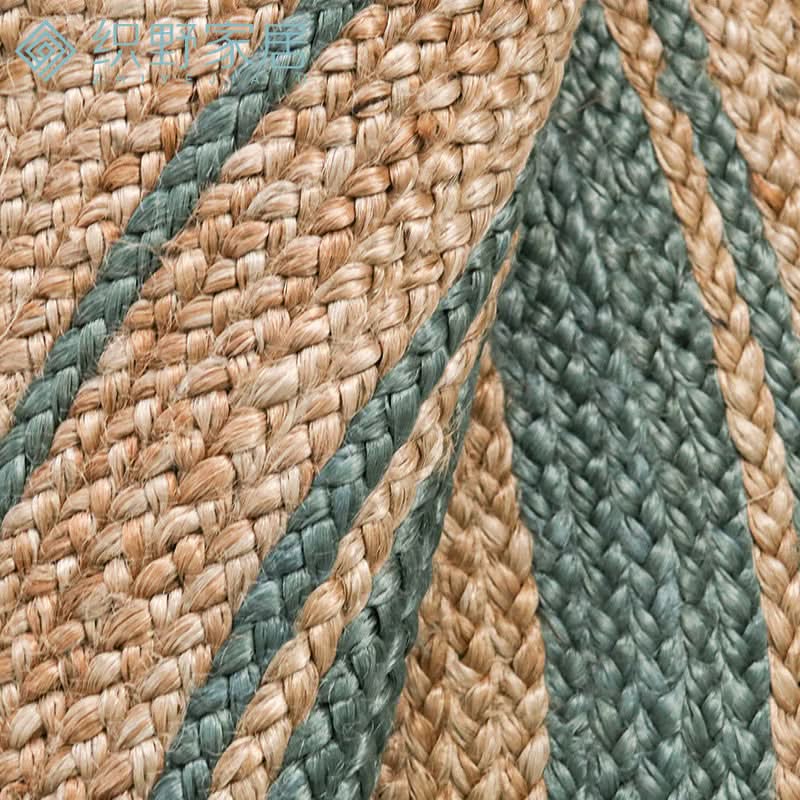 Close-up of a Round Jute Rug with natural jute and teal stripes, braided texture.