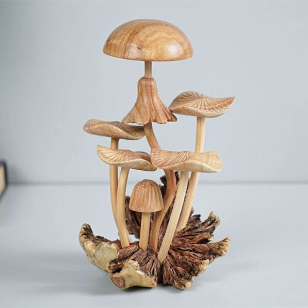 Hand-carved wooden mushroom sculpture in natural wood tones, ideal for home decor.