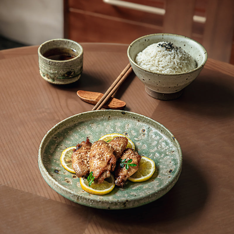 Green and brown handcrafted dinnerware set, irregular shapes, reactive glaze.