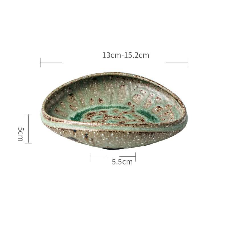 Artisan Green Dinnerware: Handmade ceramic bowl in speckled green with organic texture.