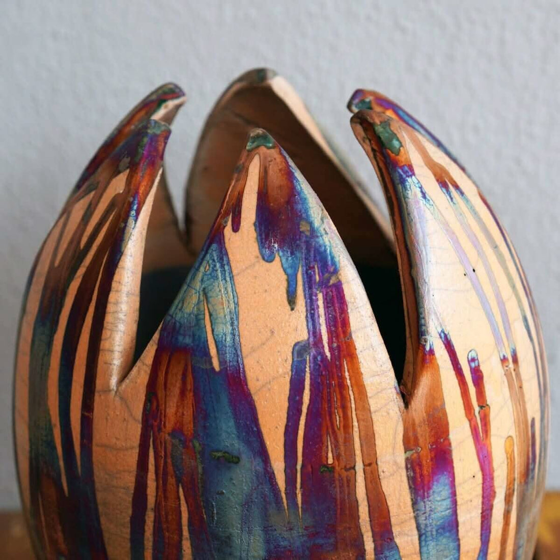 Large, colorful flower vase; raku-fired ceramic; unique design; vibrant iridescence.