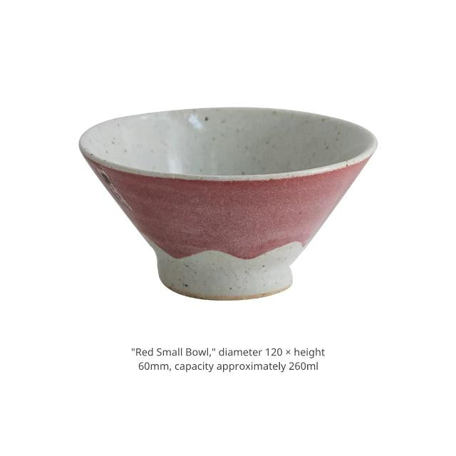 Product shot of a small dusty pink ceramic bowl with an uneven glaze line.