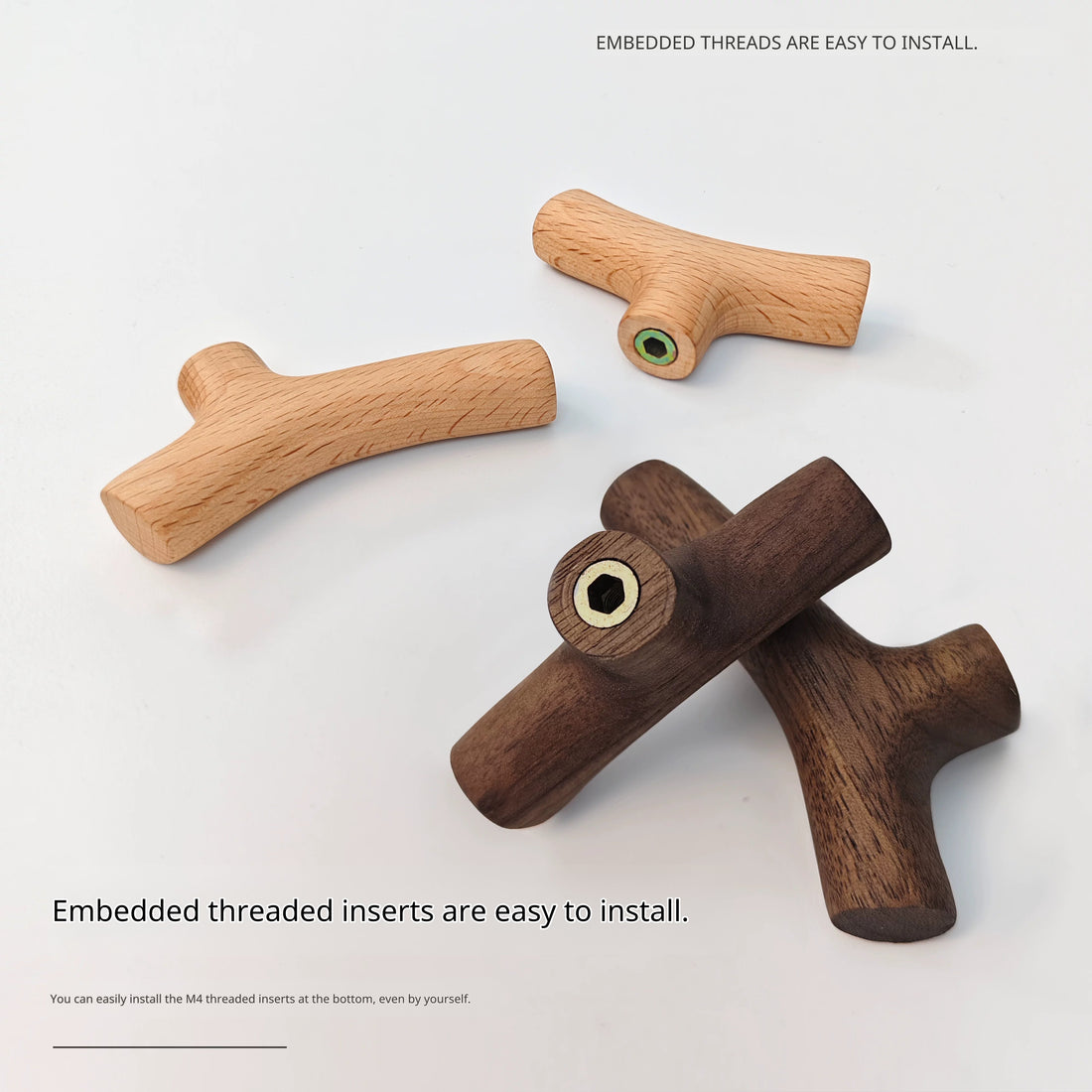 Three small wooden branch hooks, two dark walnut and one light maple, showing embedded screw threads.