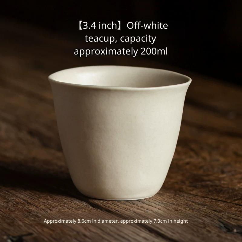 Beige-white ceramic tea or water cup (200ml capacity) with a slightly flared rim on wood.