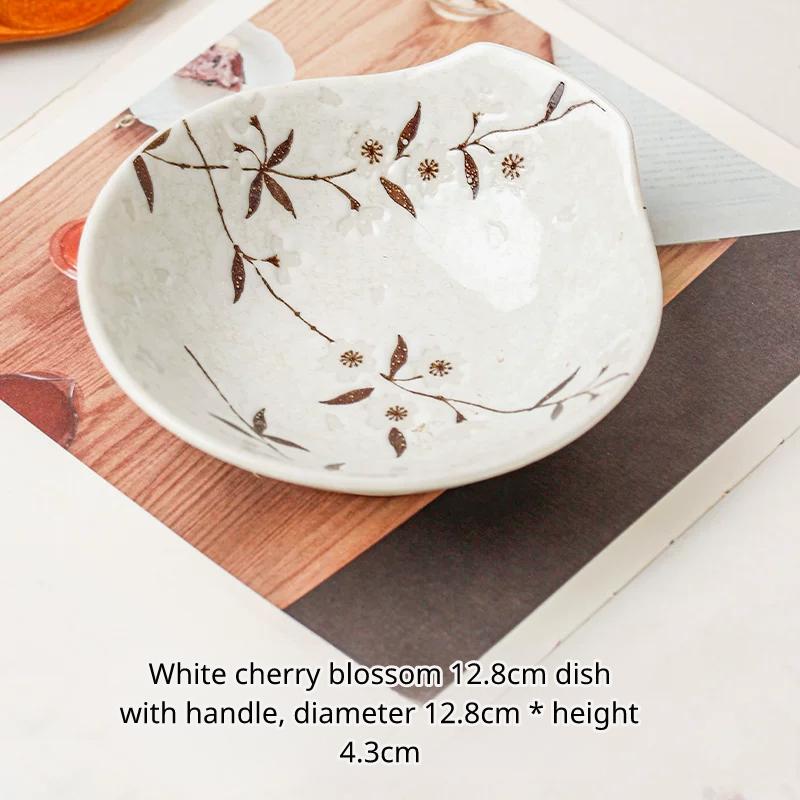 Small white ceramic bowl with handle and brown cherry blossom design, Chinese text describing size.