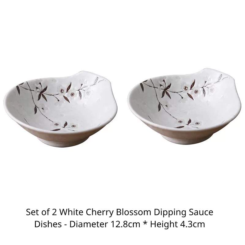 Two white ceramic sauce dishes with handles and cherry blossom pattern, 12.8cm wide.