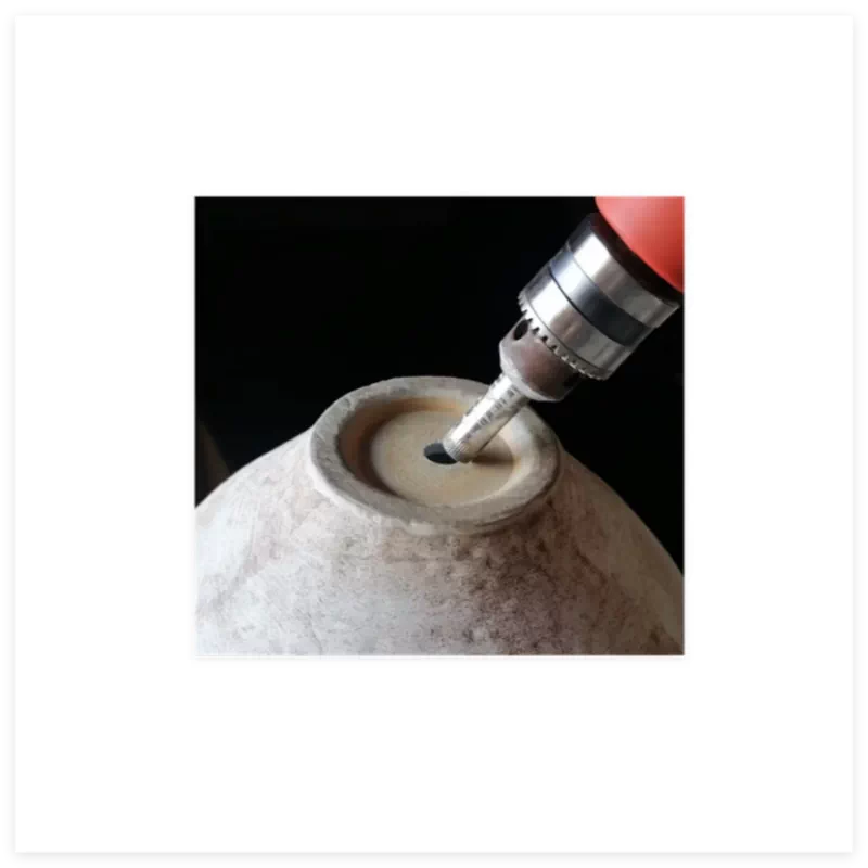 A unique handmade ceramic vase with a sculptural folded design in a neutral matte finish.