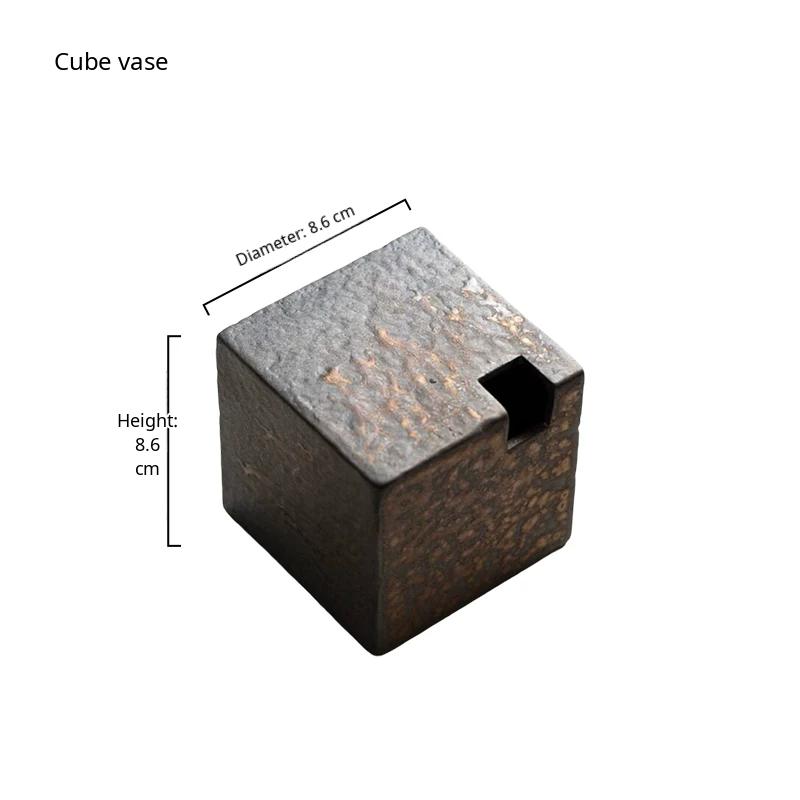 A handmade ceramic vase with a rustic stone texture and subtle metallic glaze.