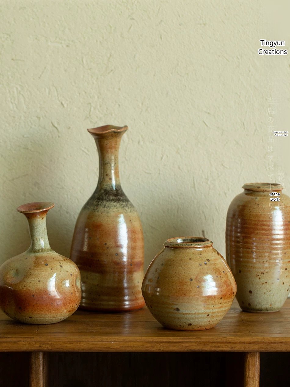 Handmade ceramic vase with a unique speckled glaze and minimalist bottle-neck shape.