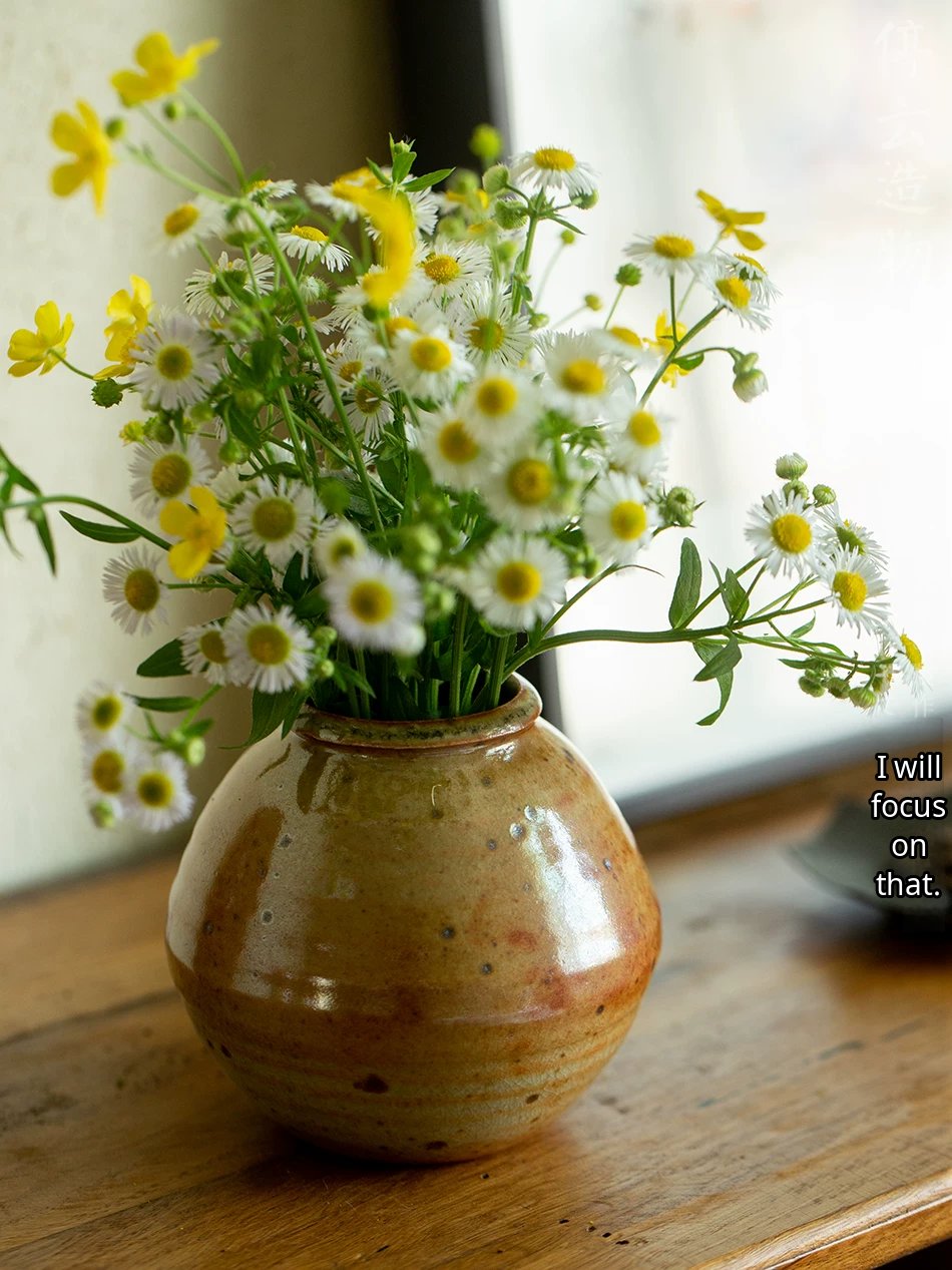 A handcrafted ceramic vase with a smooth, glossy glaze and a minimalist gourd-shaped silhouette.
