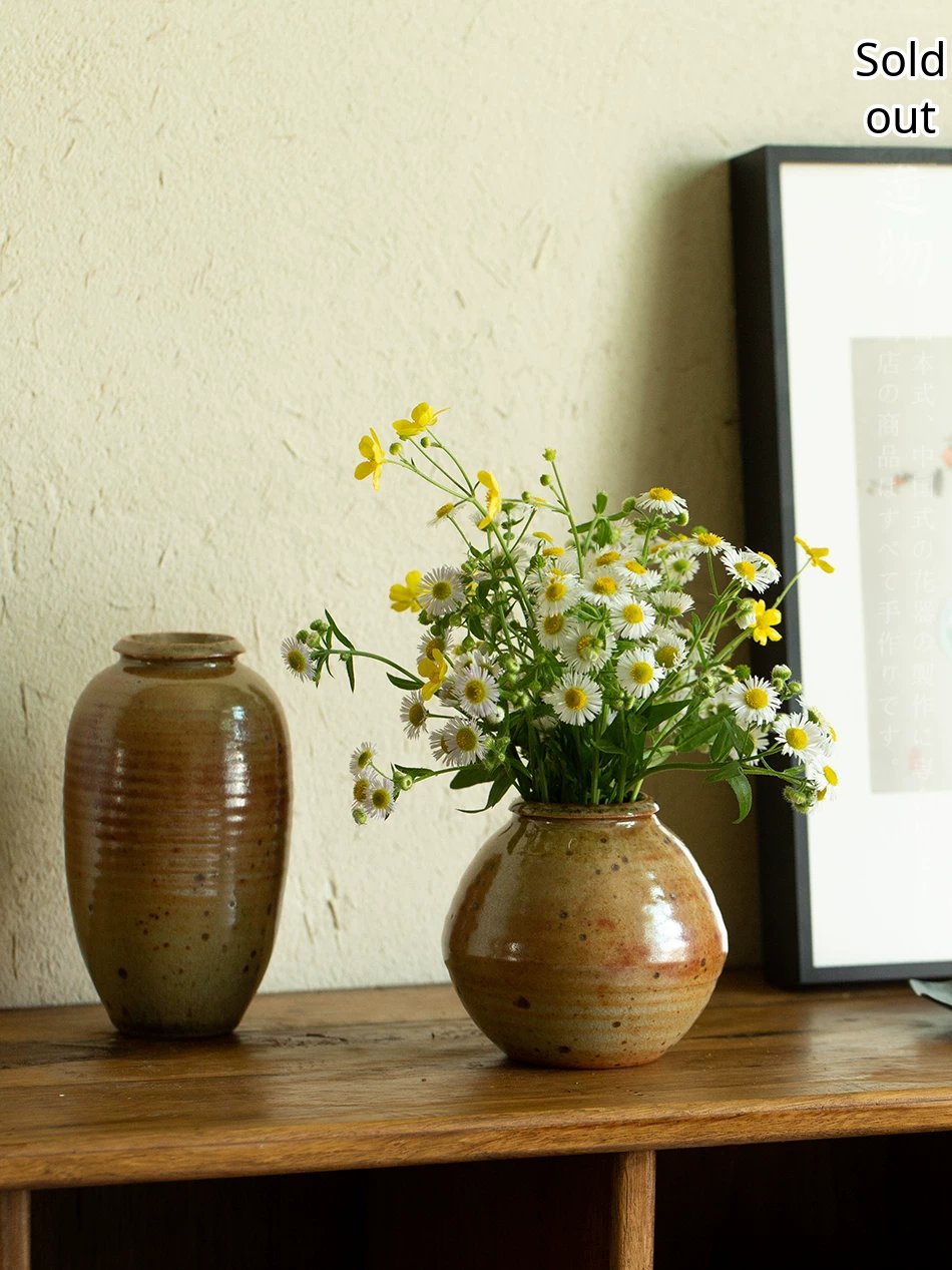 Handmade ceramic flower vase with a glossy multi-tone glaze and a minimalist silhouette.