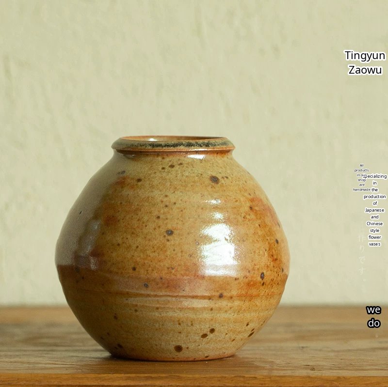 Handmade ceramic vase with a smooth, glossy green glaze and a minimalist silhouette.