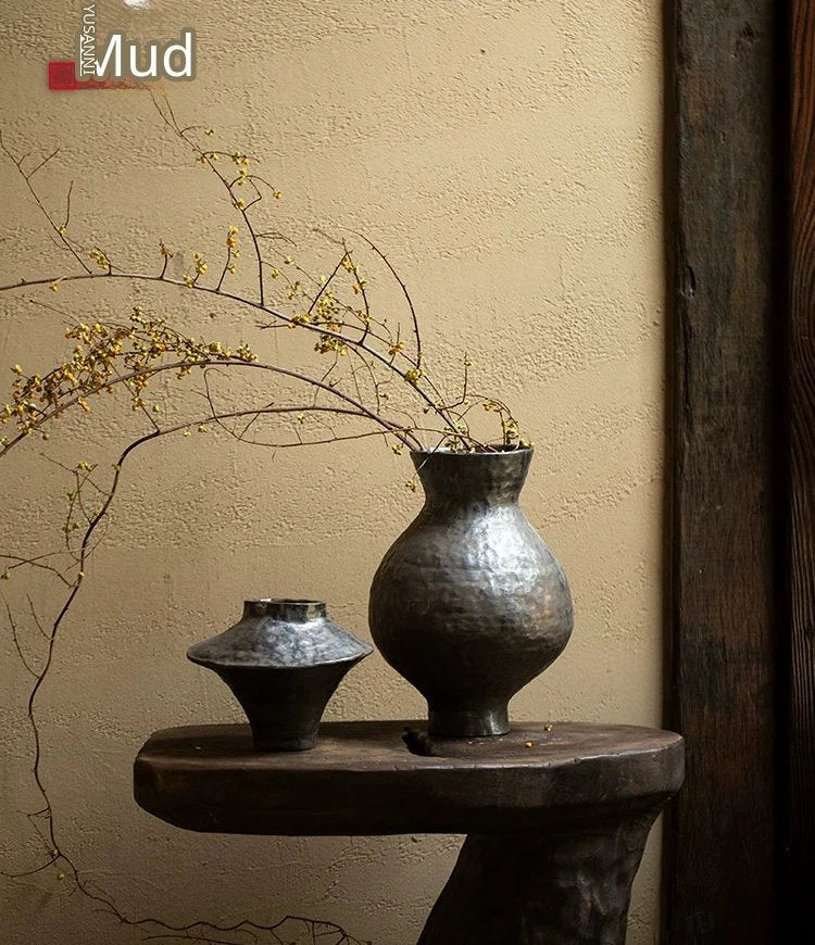 Handmade black glossy ceramic vase with a unique artisan shape, perfect for modern home decor.