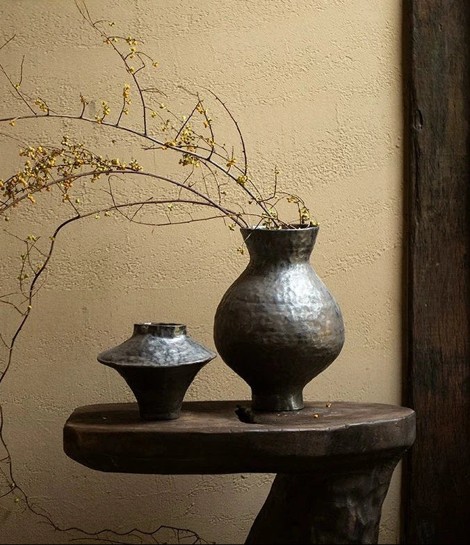 Handmade black glossy ceramic vase with a unique artisan shape, perfect for modern home decor.
