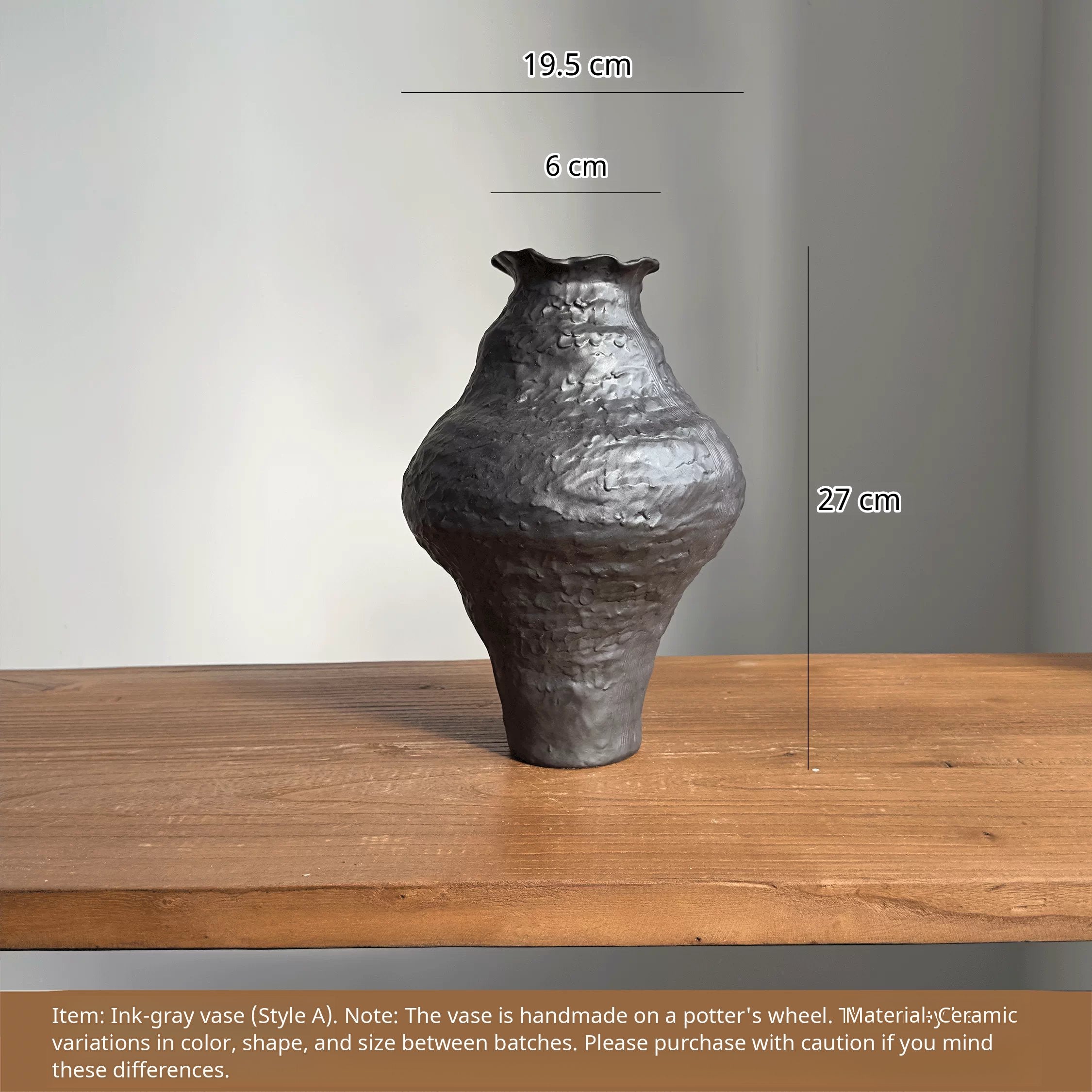 Handmade black ceramic vase with a unique textured finish and a sculptural, artistic design.