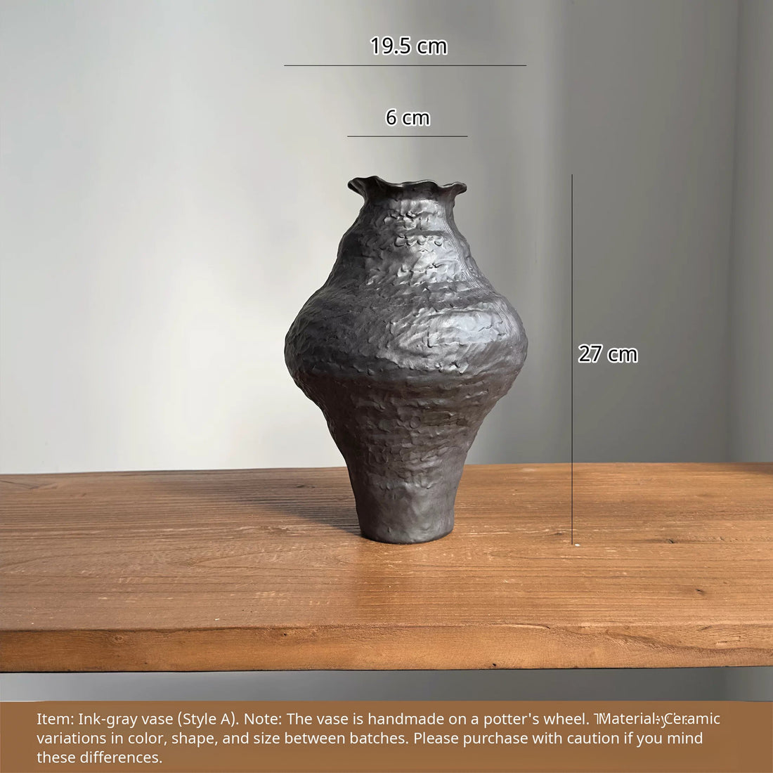 Handmade black ceramic vase with a unique textured finish and a sculptural, artistic design.