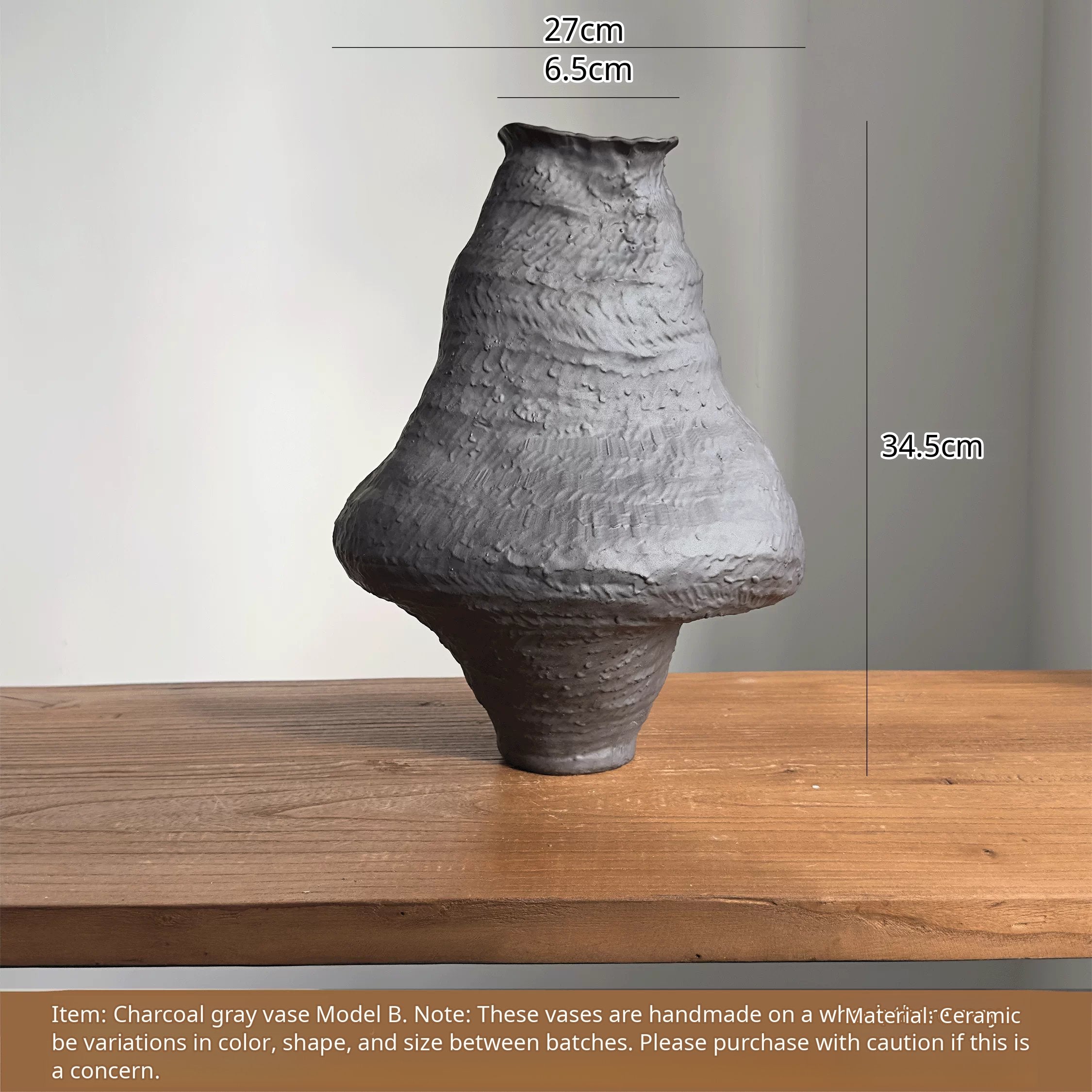 A handmade black ceramic vase with a textured clay finish and an artistic sculptural design.