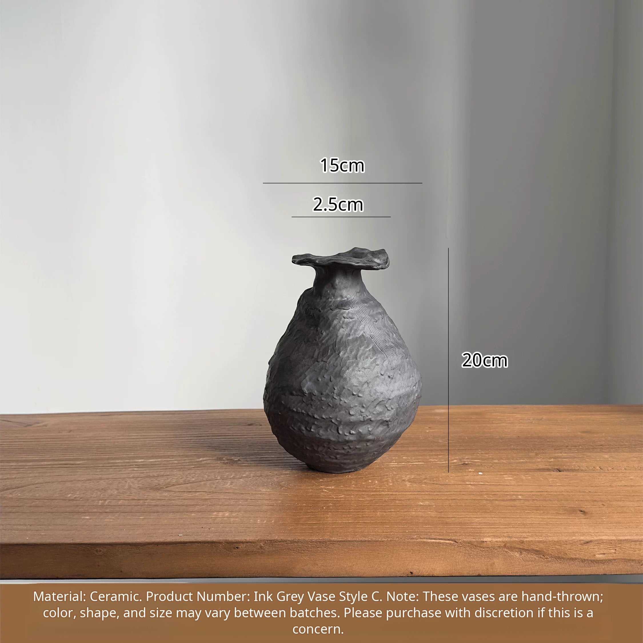 Black handmade ceramic vase with a textured, artistic sculptural design.