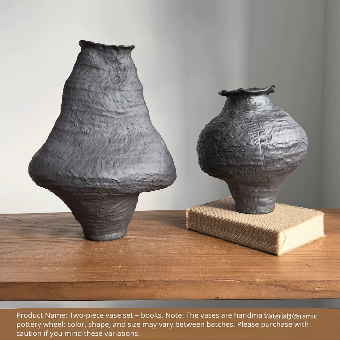 A handmade black ceramic vase with a textured clay finish and an artistic sculptural design.