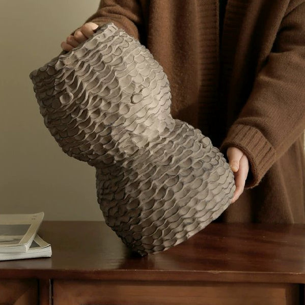 Handmade brown ceramic vase with a textured, rustic finish and a wide body.