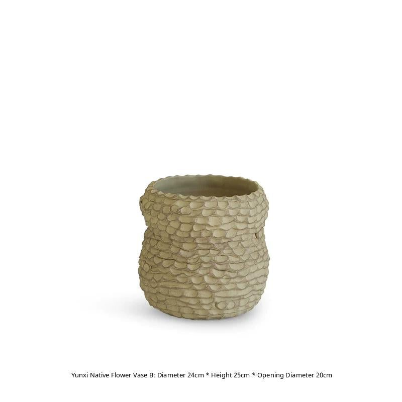 A handcrafted ceramic vase with a textured, rustic brown finish and a tapered neck.