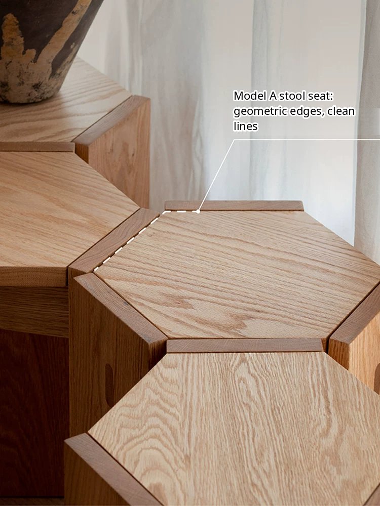A minimalist solid wood stackable stool with a geometric cutout design, functioning as a seat or side table.
