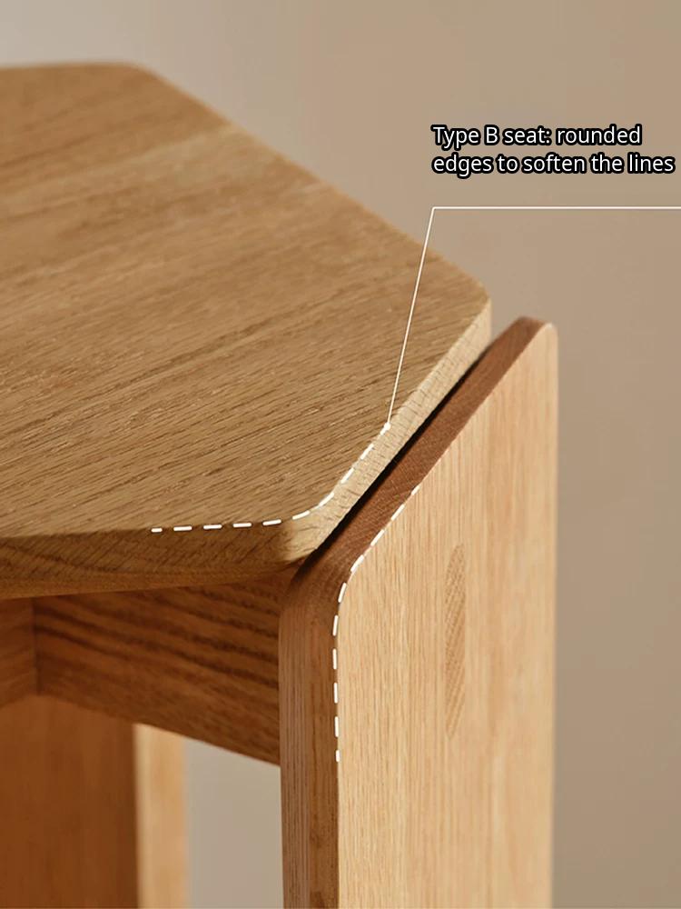 A minimalist solid wood stackable stool with a geometric design and smooth natural finish.