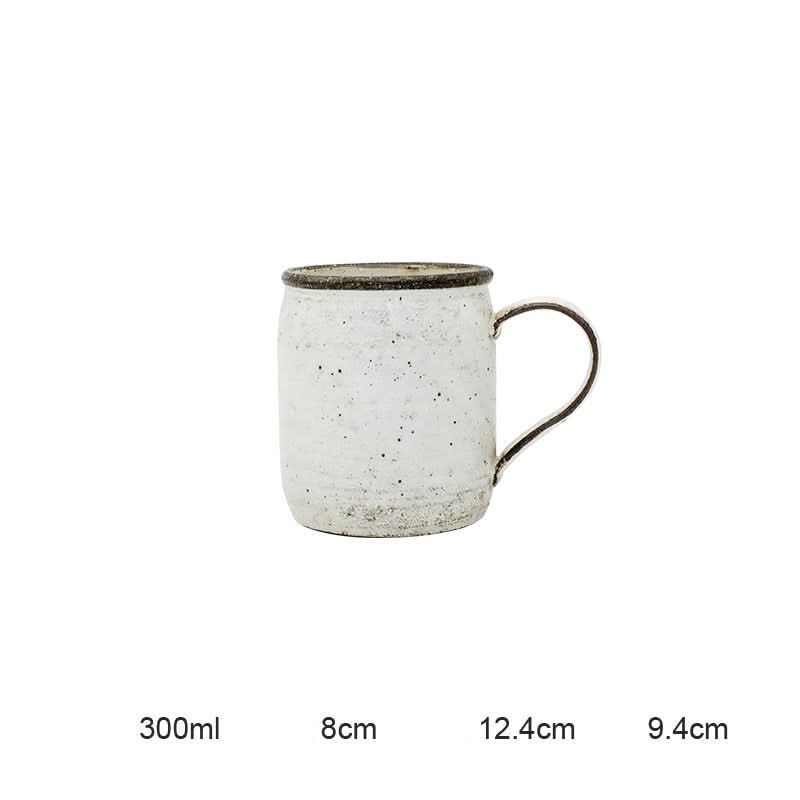 White speckled ceramic mug from the Clay Ceramic Dinnerware Set with dark rim, perfect for home decor.